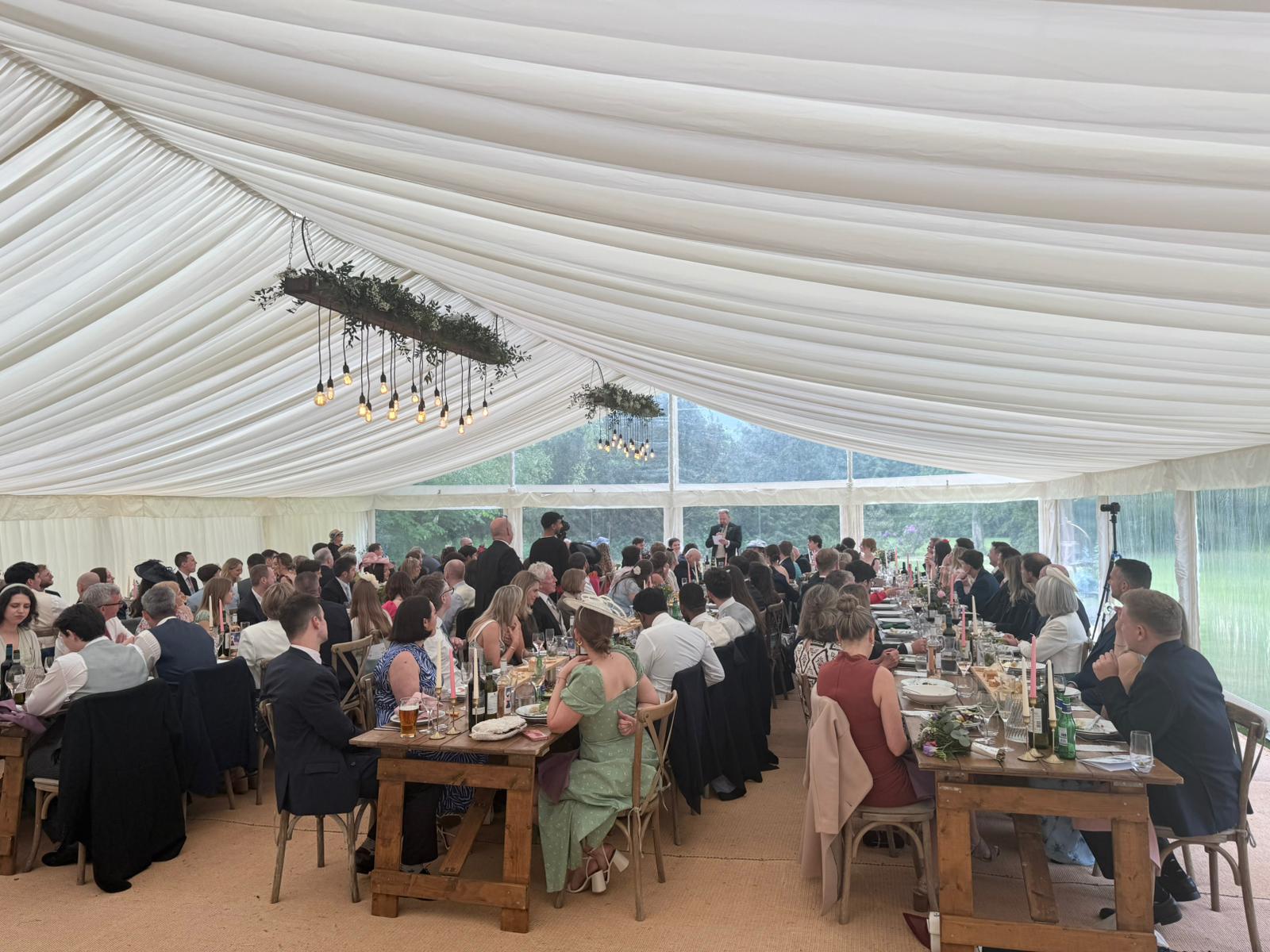Guests dining in a wedding marquee planned by E&M
