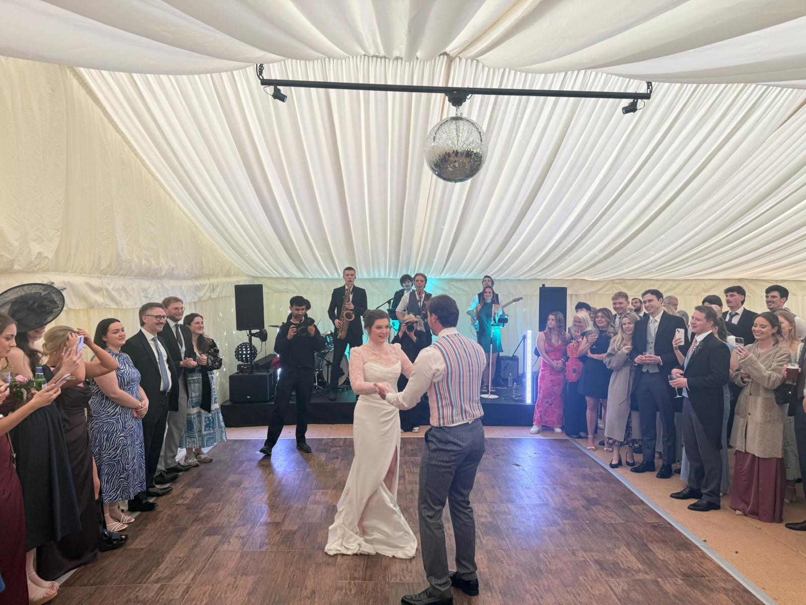Couple enjoying their first dance in a wedding marquee